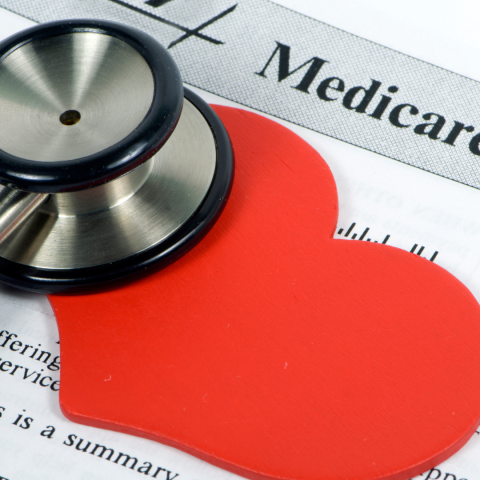 Red paper heart on Medicare document